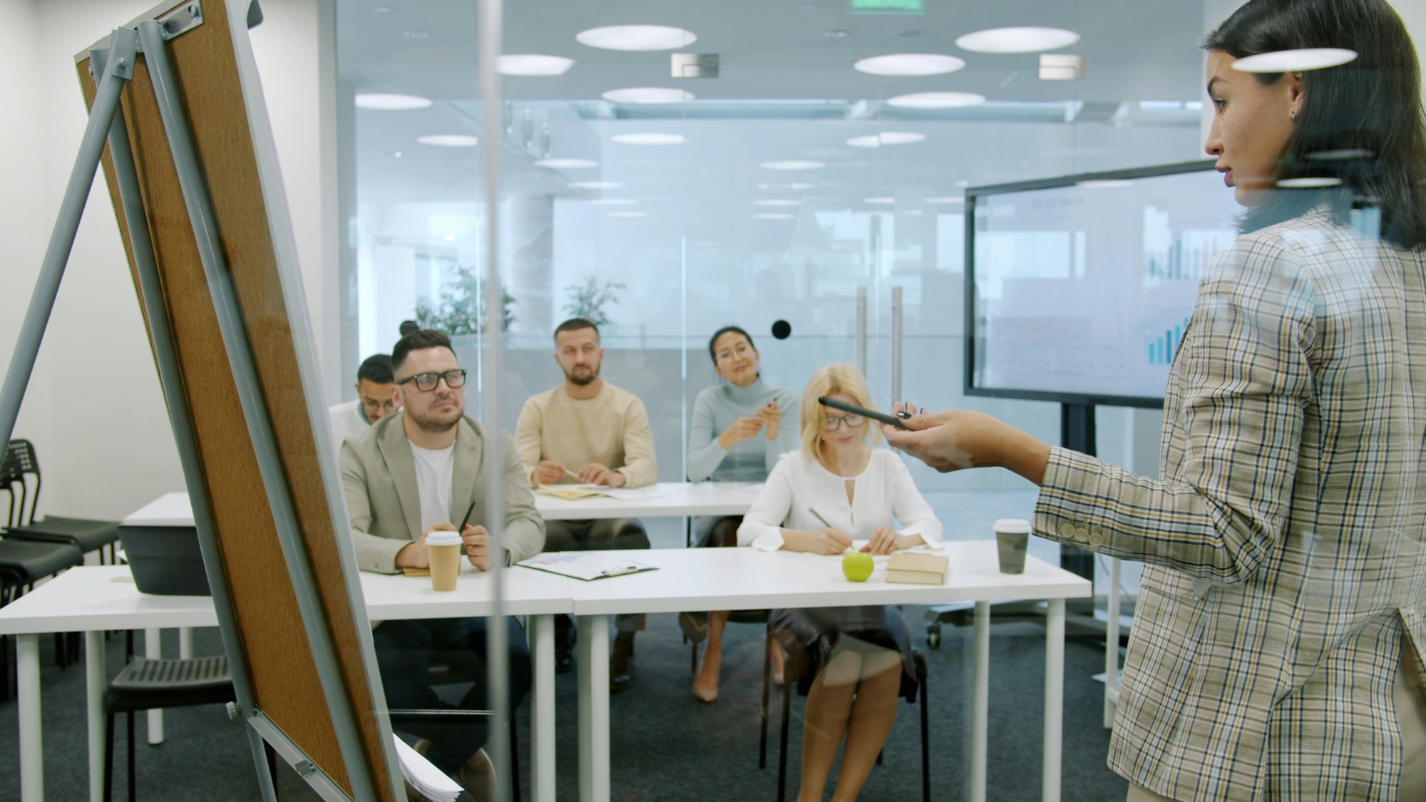 Facilitator presenting to a group in a modern office