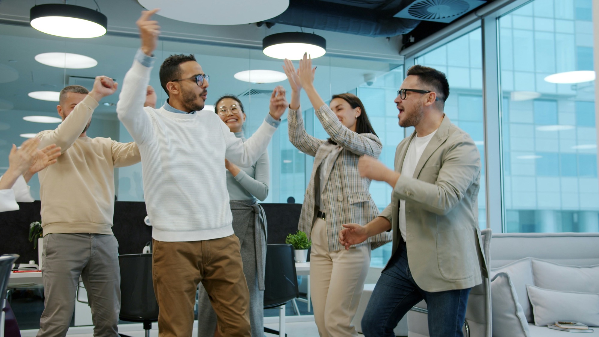 Colleagues celebrating success in an office