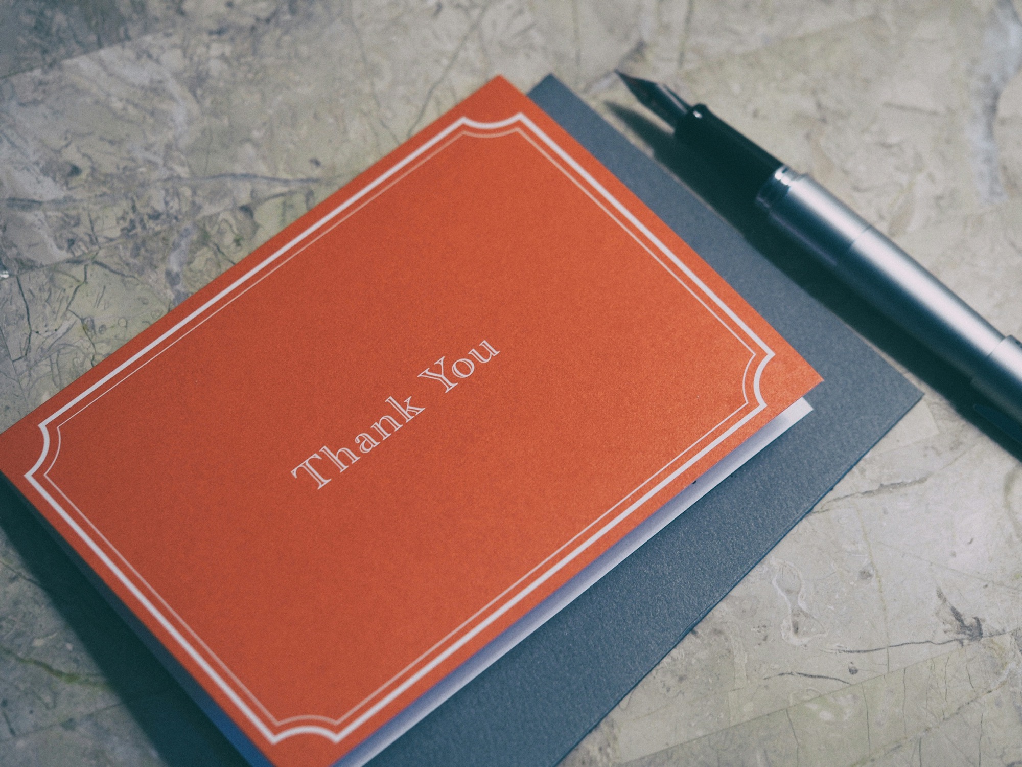 Thank you journal and fountain pen on a desk