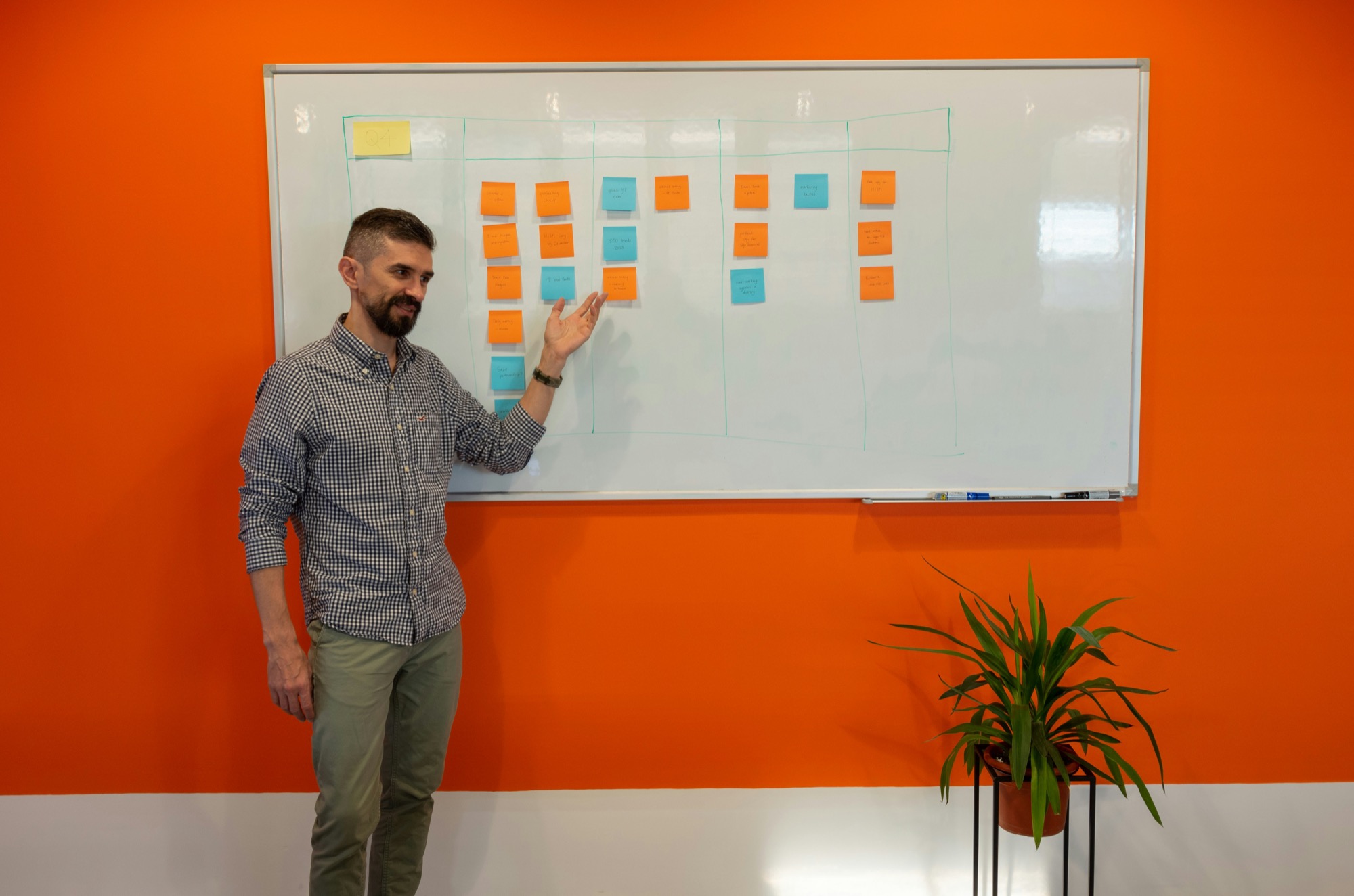 Presenter standing near a whiteboard in a meeting room