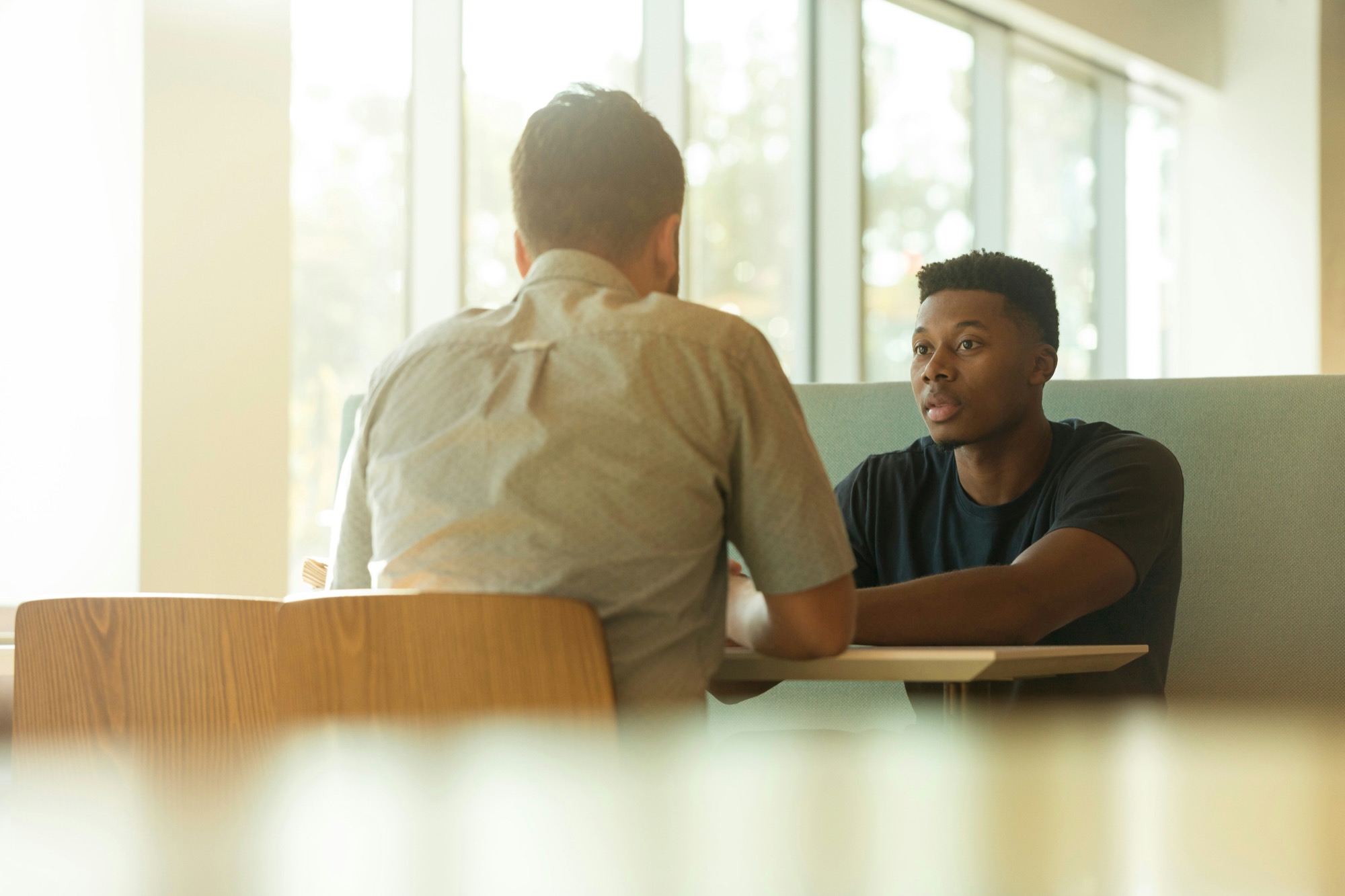 Two colleagues talking at work